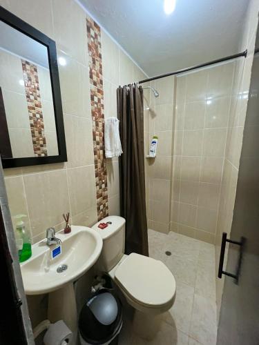 a bathroom with a toilet and a sink and a shower at Casa entera rústica con terraza, parque principal in San Vicente de Chucurí