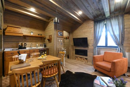 a kitchen and living room with a table and chairs at Lakeside Hotel Plitvice in Plitvička Jezera