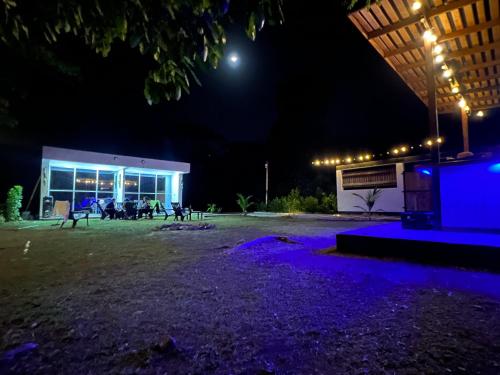 a building at night with purple lights on the ground at Hotel Magic Capurganá in Capurganá