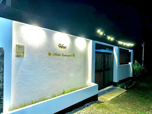 a white building with a sign on the side of it at Hotel Magic Capurganá in Capurganá