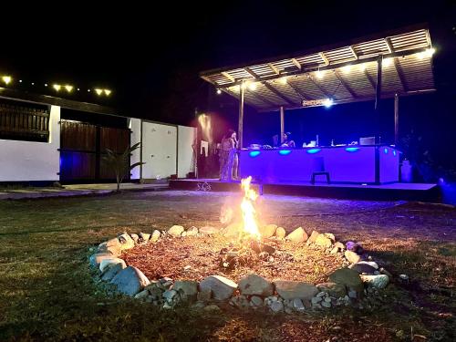 a fire pit in a yard at night at Hotel Magic Capurganá in Capurganá