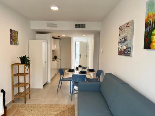 a living room with a blue couch and a table at Bnbook Medea Apartments 2 in Fuengirola