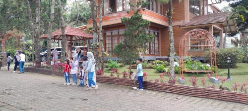 a group of people standing in front of a house at Villa Dinar Tulip VIB in Lembang