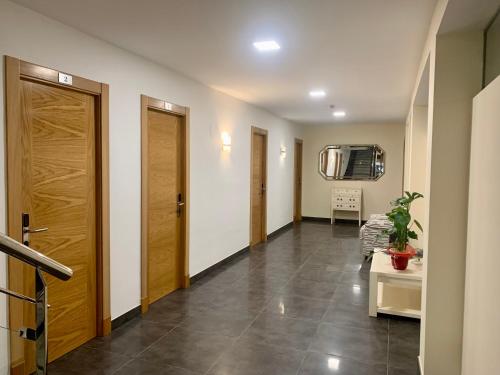 a hallway with two doors and a tile floor at Hospedium Hotel Continental in Mojácar