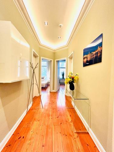 a living room with a wooden floor and a painting on the wall at Blue City Apartment’s in Hamburg