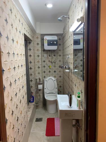 a bathroom with a toilet and a sink at Studio Apartment at UNESCO Heritage Site in Kathmandu