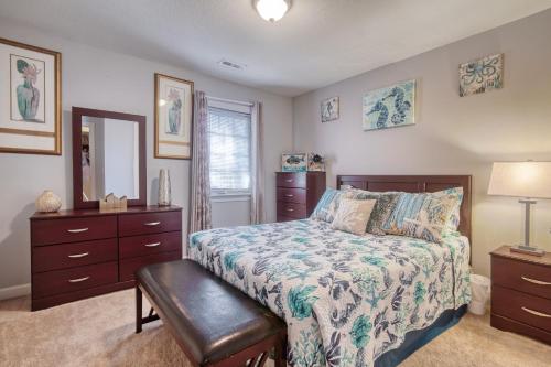 ein Schlafzimmer mit einem Bett mit einer Kommode und einem Spiegel in der Unterkunft Palm Oaks Estate in Myrtle Beach