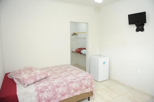 En eller flere senger på et rom på Pousada Gruta do Anjo