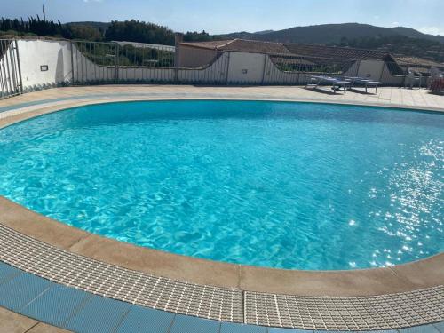 a large pool with blue water in a yard at Charming Holiday Home in Chia