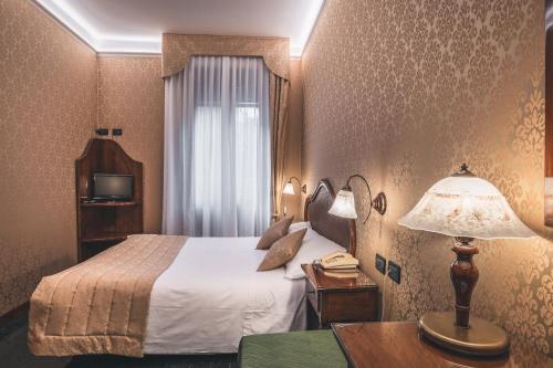 Postel nebo postele na pokoji v ubytování Hotel Al Malcanton