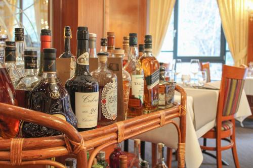 a cart full of bottles of wine on a table at Koener Hotel & Spa in Clervaux