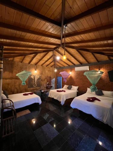 a bedroom with two beds in a room at Ceylon Resort in Wilpattu
