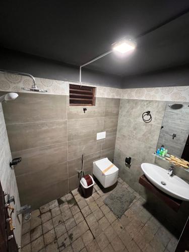 a bathroom with a sink and a toilet at Ceylon Resort in Wilpattu