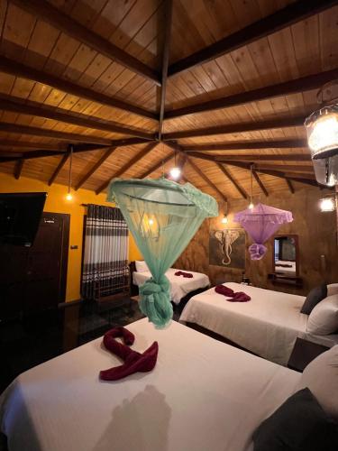 a room with two beds with red shoes on them at Ceylon Resort in Wilpattu