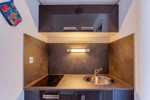 a kitchen with a sink and a stove at Les Laurentides in Villarembert