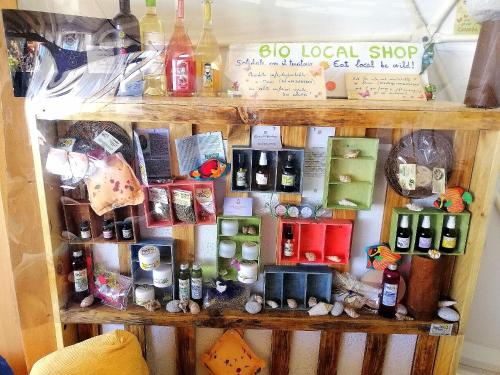 a shelf filled with lots of different types of items at Agriturismo Glamping Erbe Matte in SantʼAntìoco
