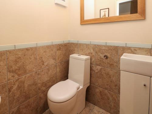 a bathroom with a toilet and a sink at Glenhurst in Dronfield