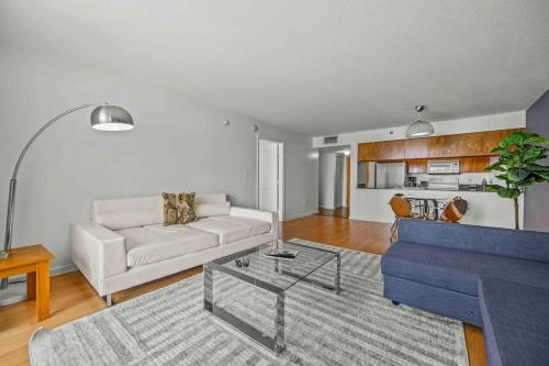 a living room with a white couch and a table at Amazing cozy Condo in Brickell Miami in Miami