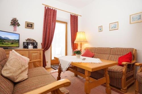 a living room with a couch and a table at Haus Regner in Reit im Winkl