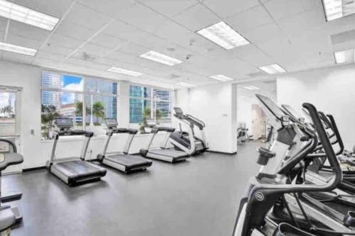 a gym with treadmills and elliptical machines at Amazing cozy Condo in Brickell Miami in Miami