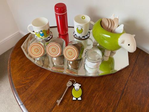 a glass tray with cups and other items on a table at North View B&B in Penrith