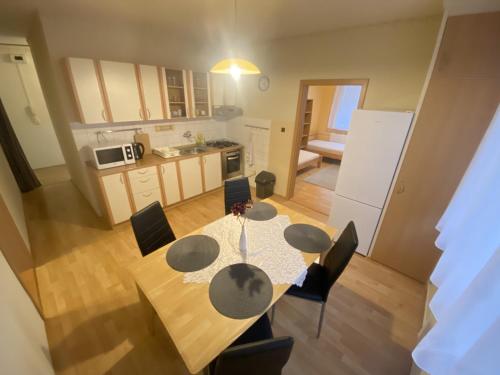 a kitchen and dining room with a table and chairs at ARD City Apartment in Levice