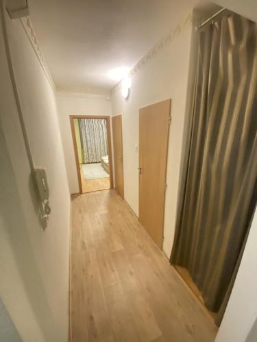 a hallway of a house with a door and wooden floors at Apartmán Jasmin Levice in Levice