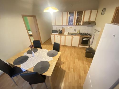 a kitchen and dining room with a table and chairs at ARD City Apartment in Levice