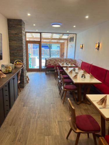 a restaurant with wooden tables and red chairs at Gasthof Löwen in Pfronten