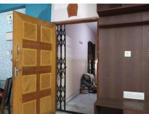 a wooden door in a room with a hallway at home stay guest house in Kolkata