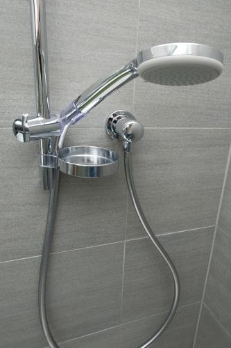 a shower with a shower head in a bathroom at Ferienwohnung Robi in Fulpmes
