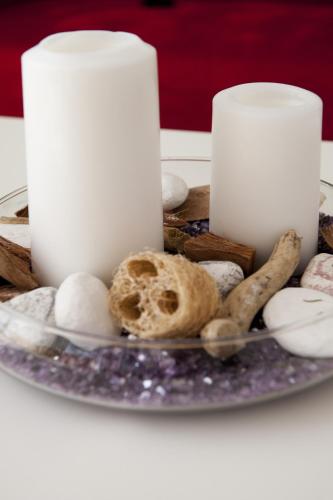 a plate with a candle and some shells on a table at Ferienwohnung Robi in Fulpmes