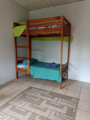 two bunk beds in a room with a rug at The Sweet Escape Cabinas in Sierpe