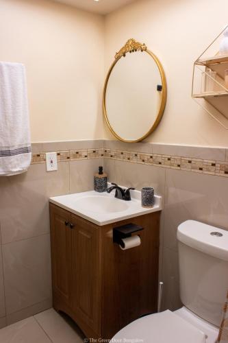 a bathroom with a sink and a mirror at The Green Door Bungalow in Naples