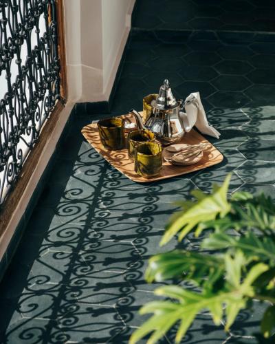 a tray with a tea kettle on a table on the floor at Riad no37 in Marrakech