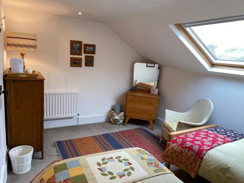 a attic bedroom with a bed and a window at North View B&B in Penrith