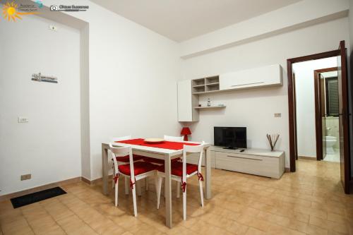 a kitchen with a table and chairs in a room at Cannotta Beach - Lipari in Terme Vigliatore