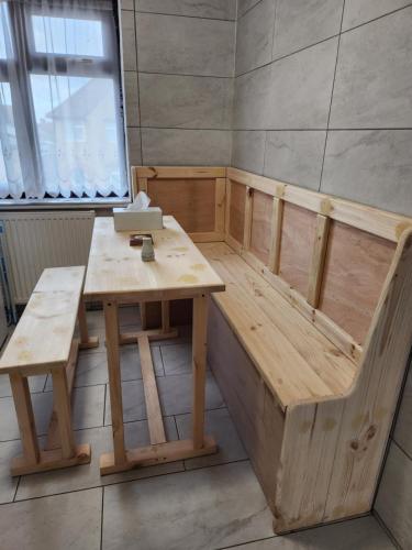 a sauna with a table and bench in a room at 12 Minutes to Central London Kings Cross, 6 minutes walks to the train station - Free parking 3 bed 2 bath fully refurbished flat NO PARTY OR GATHERING ALLOWED in London