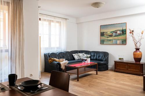 a living room with a couch and a table at LeoApart in Wrocław