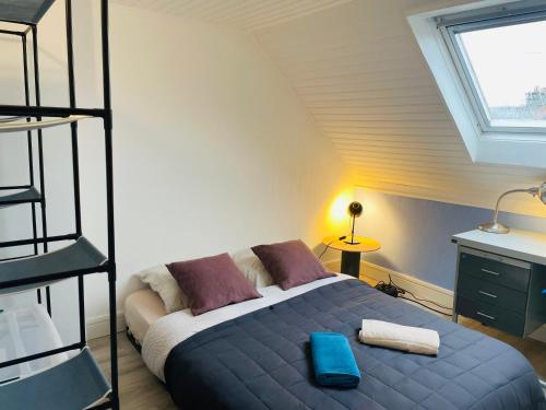 a bedroom with a bed in a room with a ladder at Le Duplex 3 chambres - 1P à 7P - Saint Honore in Amiens
