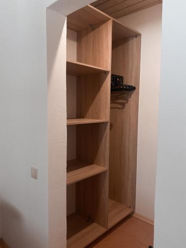a closet with wooden shelves in a room at Hillside in Slavske