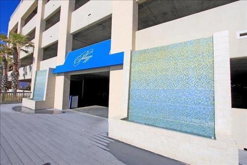 a building with a blue sign on the side of it at Palazzo 408 in Panama City Beach