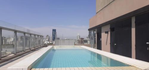 a swimming pool on the roof of a building at Apartamento Av kennedy y Cerviño a metros embajada EEUU in Buenos Aires