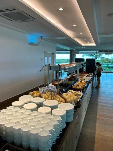 a buffet line with white plates and other food at SALINAS PARK RESORT in Salinópolis
