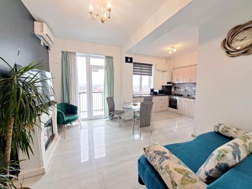 a living room with a couch and a dining room at Highsky Oradea Apartments in Oradea