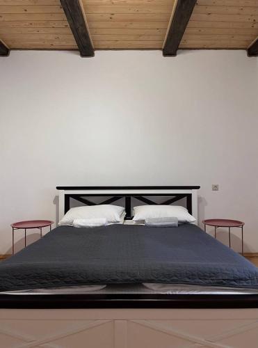 a large bed with two red chairs at the top at Hillside in Slavske