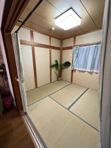 an empty room with a door and a window at 舟荘 in Osaka