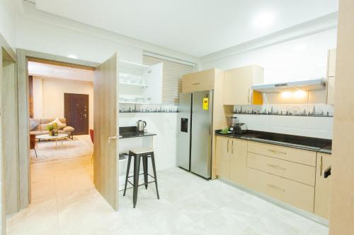 a large kitchen with a counter and a table at Accra Luxury Homes @ Achimota in Lapaz