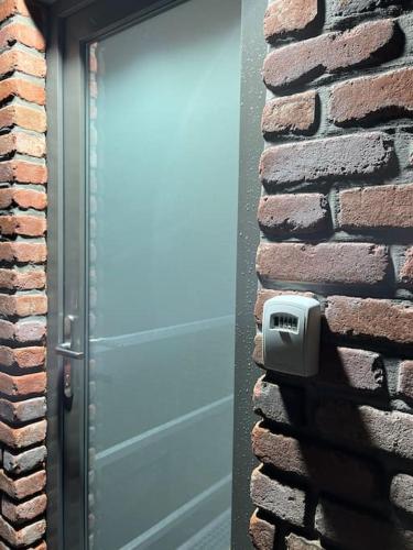 a blue garage door on a brick building at le Grand Vivier- 68 M2 in Héron