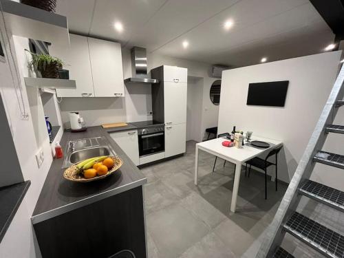 a kitchen with a bowl of fruit on a counter at le Grand Vivier- 68 M2 in Héron
